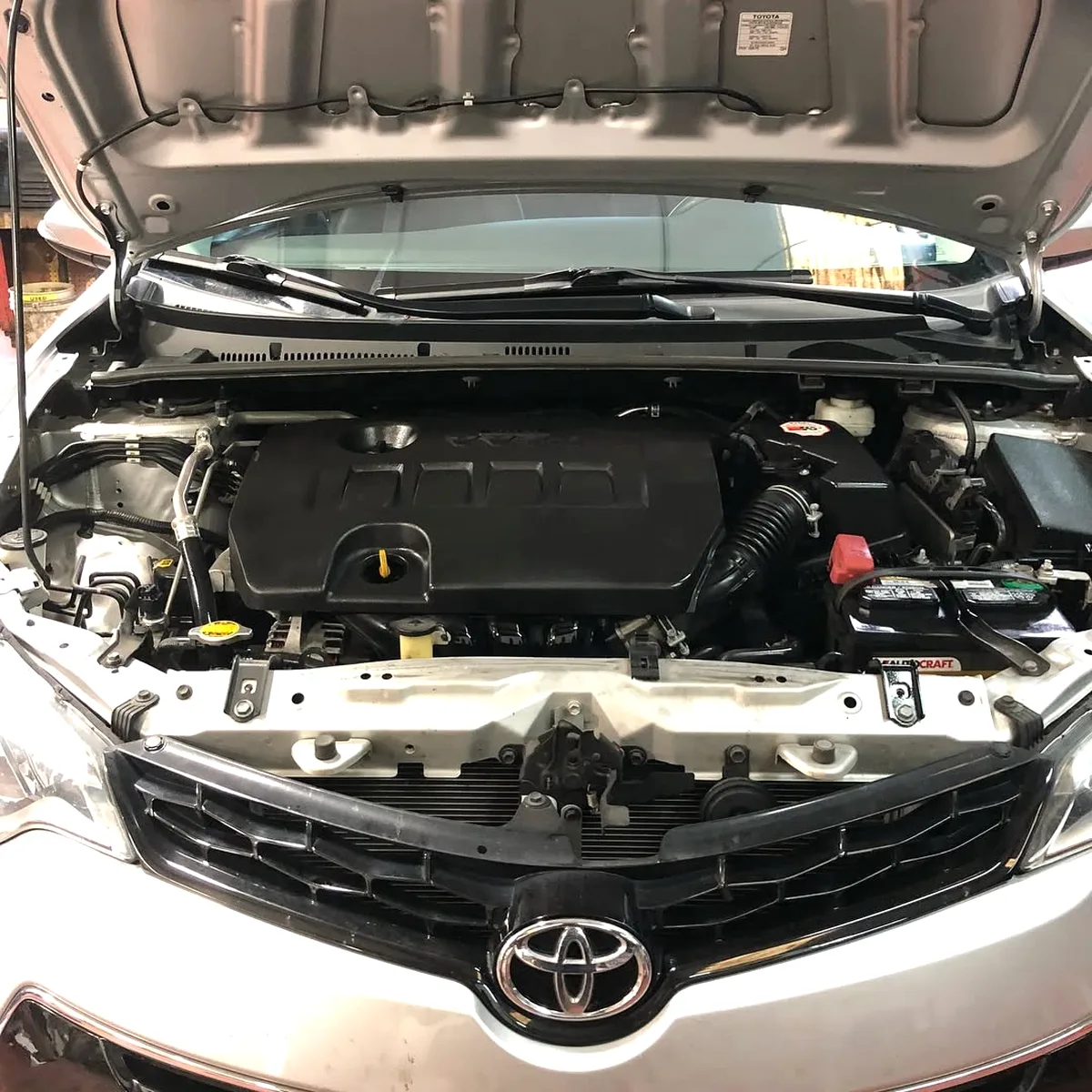 Under the hood: fluid reservoirs, belts, and battery